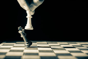 Black chess king being knocked over by white piece- Gr-stocks-Unsplash