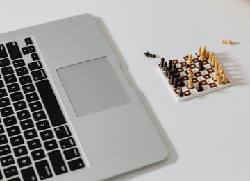 Tiny Chess Set and Laptop - Pexels - Karolina Brabowska