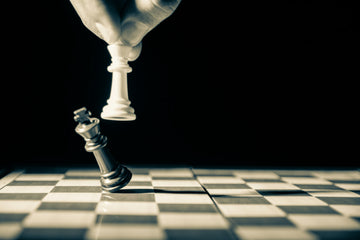 White King toppling a black chess king- GR-stocks-unsplash