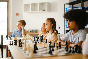 Children sitting attentively at chess boards
